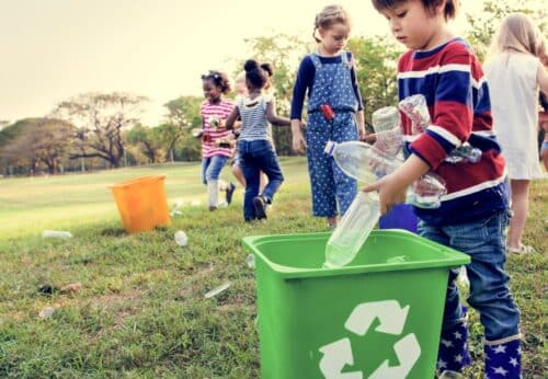Children enjoying outdoor activities while responsibly engaging in recycling efforts.
