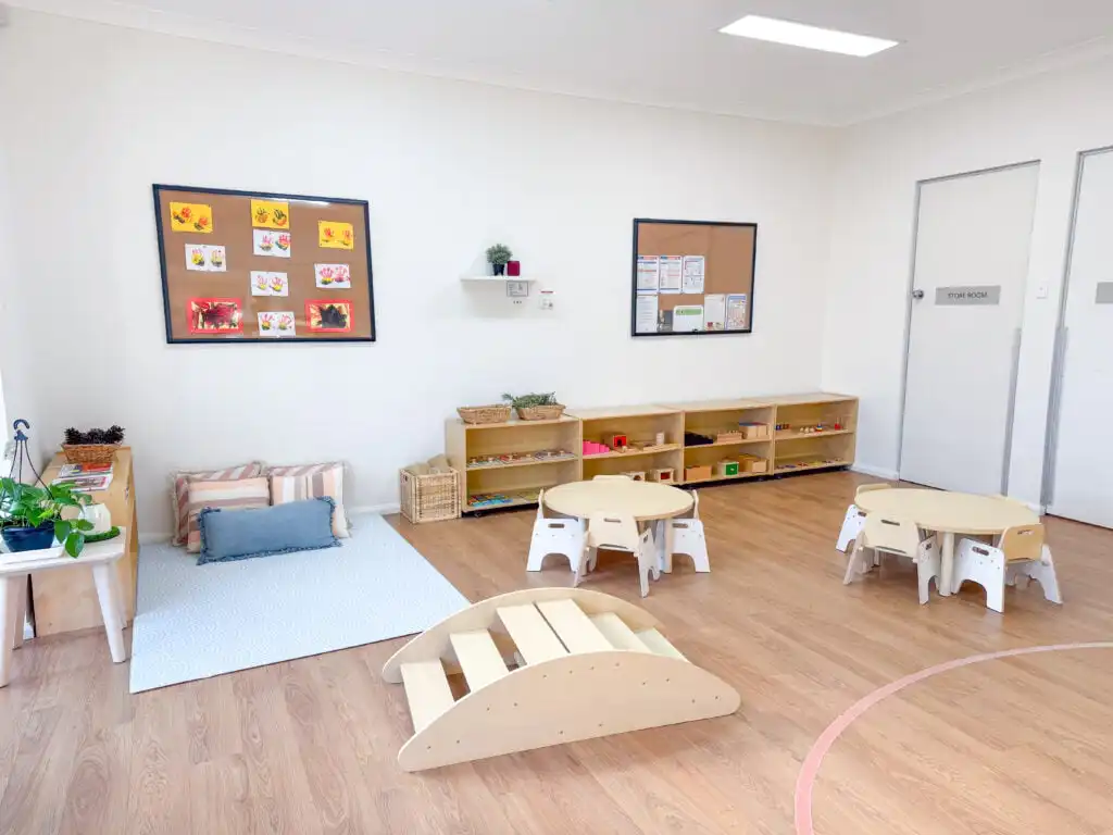 Montessori classroom at Auburn Albert Road childcare with low tables, learning shelves, soft play mat and balance equipment