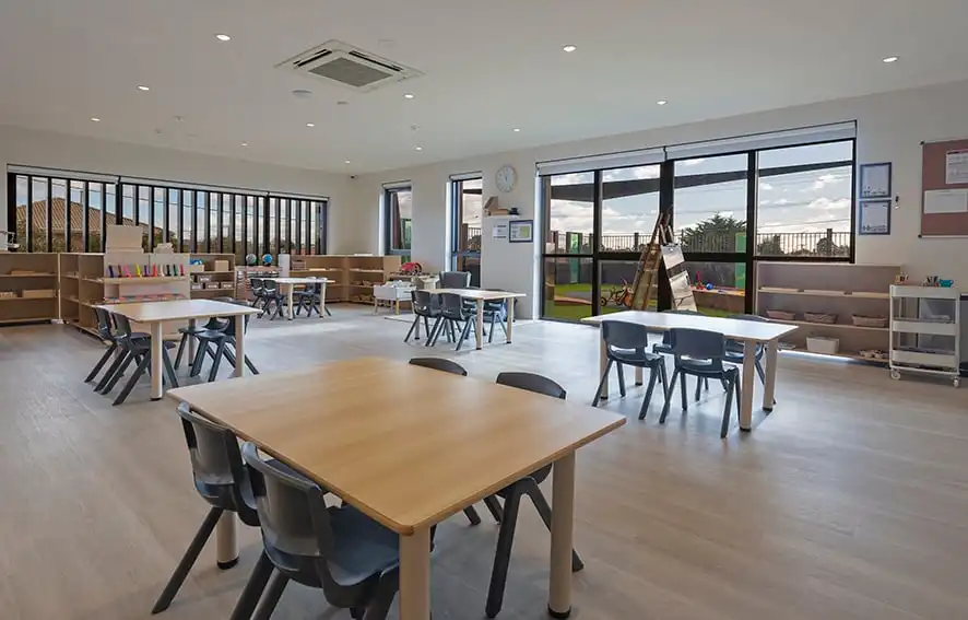 Childcare Preschool Classroom with Montessori Materials and Desks