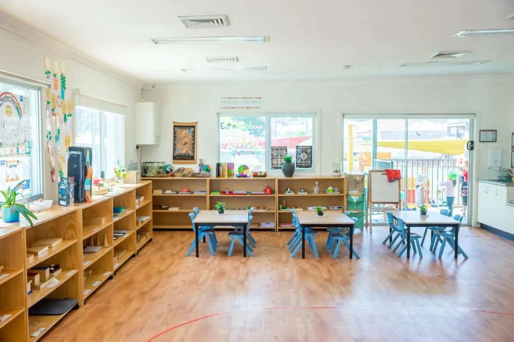 Bright Montessori classroom at Condell Park Montessori Academy with activity tables and learning shelves