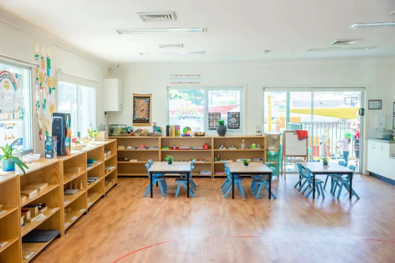 Bright Montessori classroom at Condell Park Montessori Academy with activity tables and learning shelves