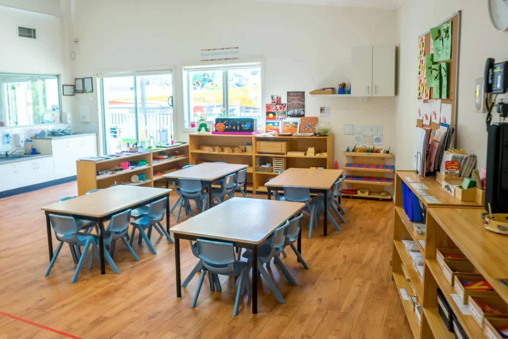 Montessori classroom at Condell Park Montessori Academy with activity tables and learning shelves