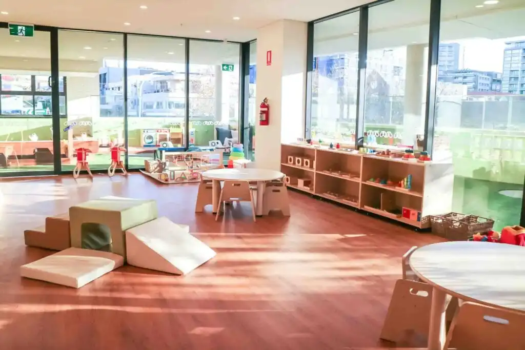 Montessori classroom at Crows Nest childcare with soft play equipment, wooden furniture, learning shelves and large windows