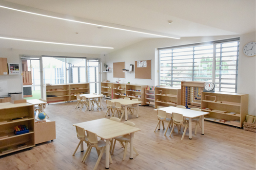 Kindergarten classroom at Elsternwick Montessori Academy with child-sized furniture and Montessori materials.