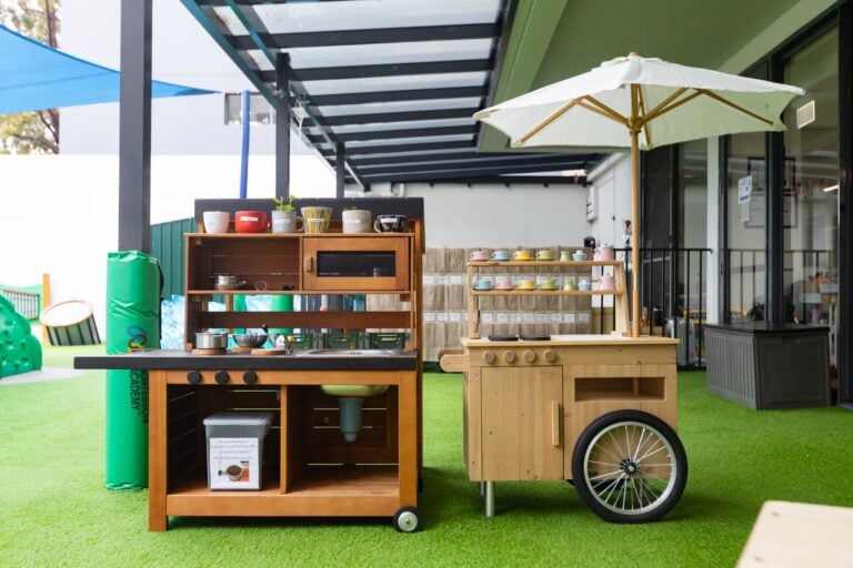 Outdoor play kitchen at Entrada Parramatta childcare centre with shaded learning and pretend play equipment
