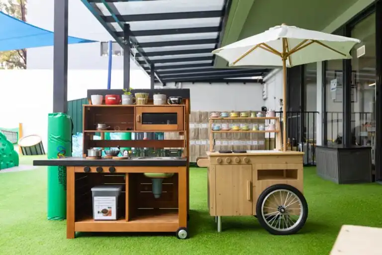 Outdoor play kitchen at Entrada Parramatta childcare centre with shaded learning and pretend play equipment