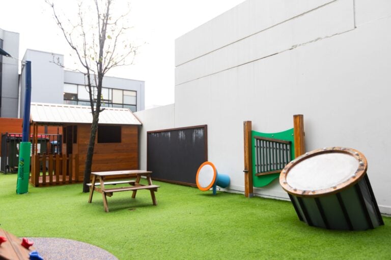 Outdoor play area at Entrada Parramatta childcare centre with climbing equipment and open play space