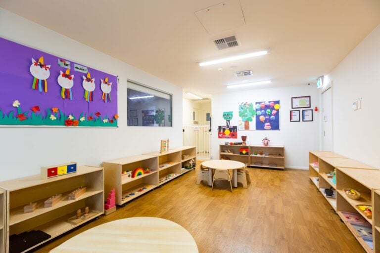 Bright Montessori classroom at Entrada Parramatta childcare centre with activity tables and learning shelves