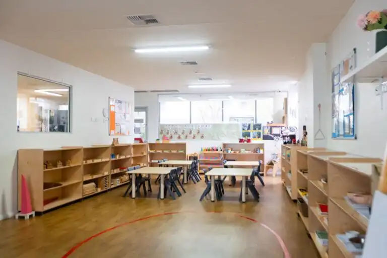 Early learning classroom at Entrada Parramatta childcare centre with activity tables and open learning shelves