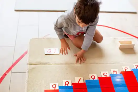 Child completing Montessori maths activity at Montessori Academy Macquarie Park childcare