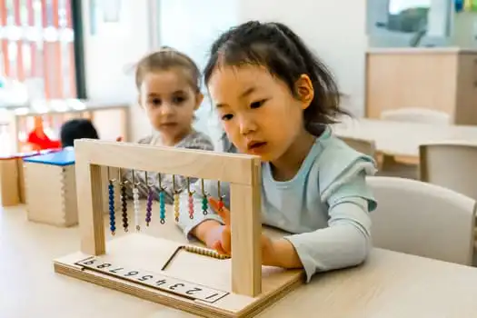 Child using Montessori bead counting material at Macquarie Park Montessori Academy childcare