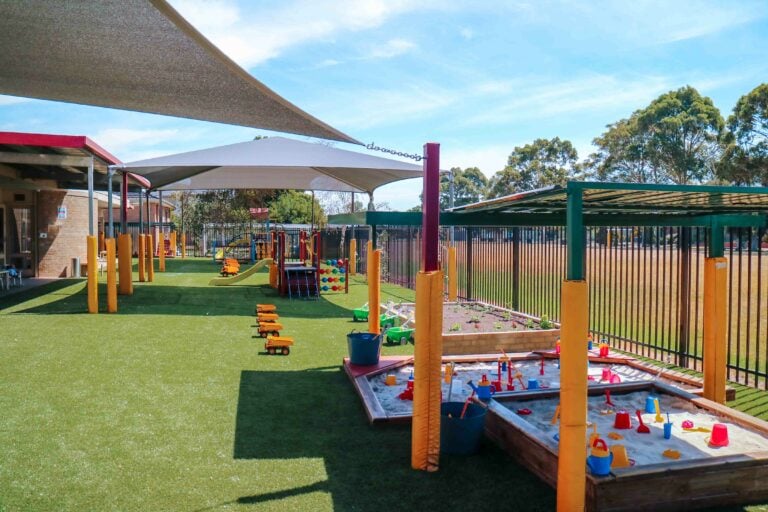 Childcare Outdoor Playground with sandpit, climbing frames, and play equipment