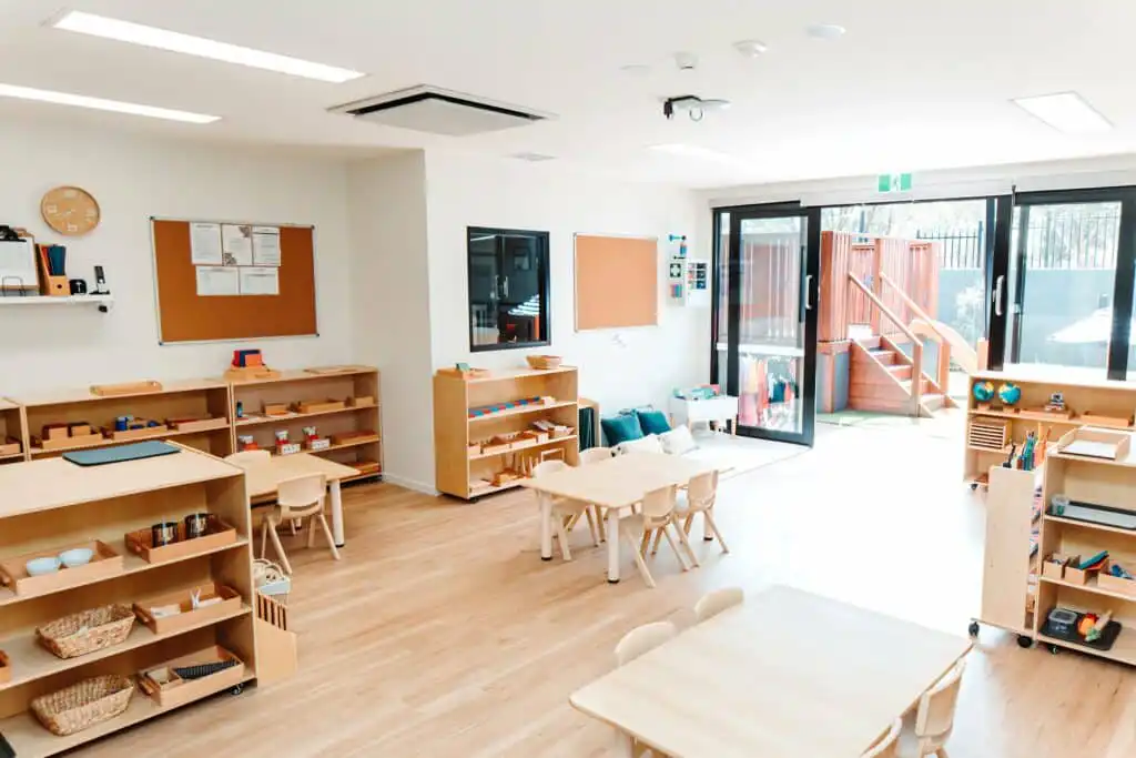 Classroom interior at Montessori Academy’s Templestowe childcare, with shelves of educational materials and small tables.