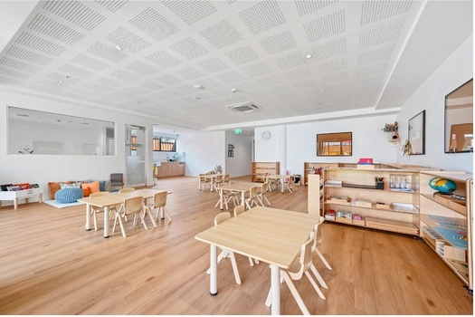 Spacious Montessori classroom at Penrith Derby Street Montessori Academy with activity tables and learning shelves