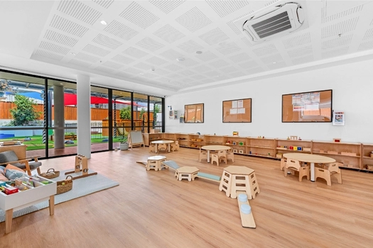 Montessori classroom at Penrith Derby Street Montessori Academy with activity tables and learning shelves
