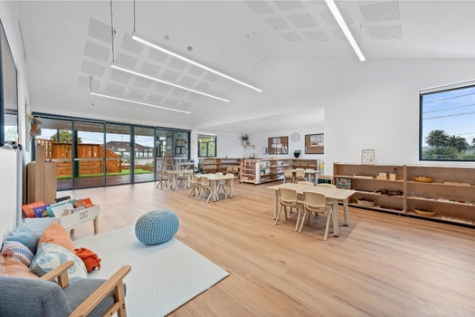 Montessori classroom at Penrith Derby Street Montessori Academy with reading area, activity tables and learning shelves