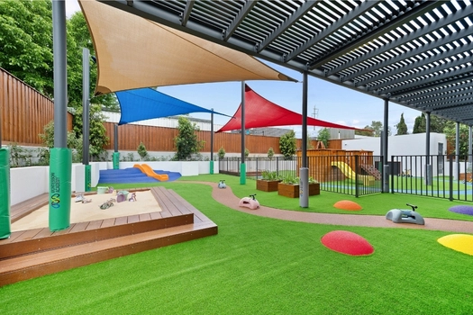 Outdoor play area at Penrith Derby Street Montessori Academy with sandpit and open play space