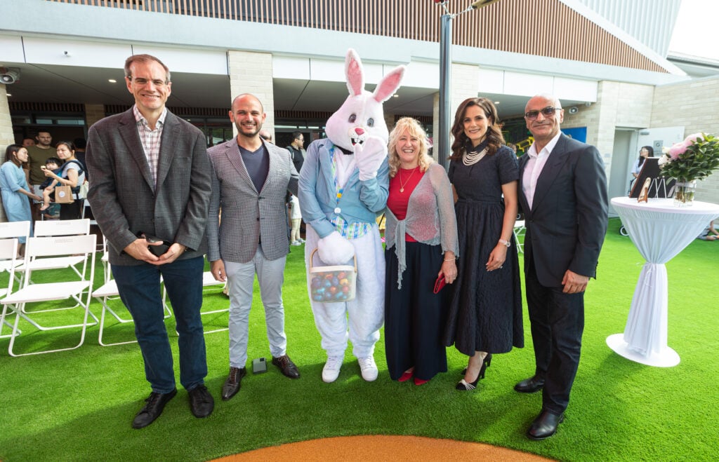 Senior community leaders stand together with an Easter Bunny at the grand opening of a Montessori childcare centre in Panania, NSW.