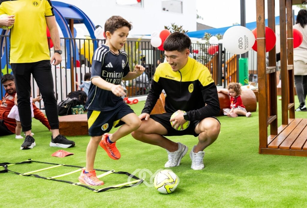 Children enjoy running through a ladder and soccer activities outdoors at Winston Hills Montessori Grand Opening.