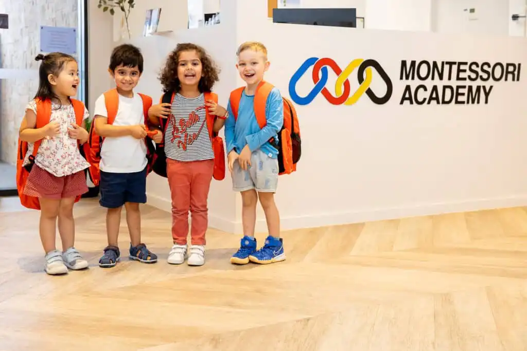 Montessori Preschoolers Showing School Readiness with backpacks ready for school