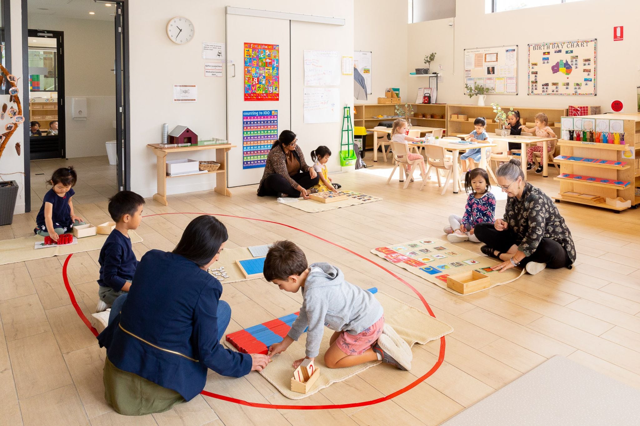 Children engaged in the Montessori work cycle at Montessori Academy