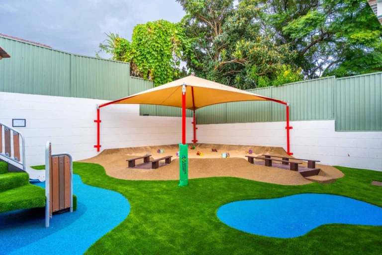 Shaded sandpit at Hurstville childcare centre with soft-fall play areas and outdoor learning space