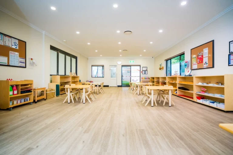 Wide Montessori classroom at Hurstville childcare centre with learning shelves and child-sized tables