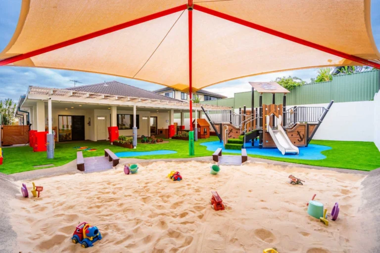 Shaded outdoor playground at Hurstville Montessori Academy with sandpit, slide and soft-fall play area