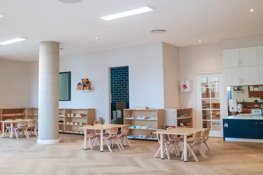 Toddler Montessori classroom at Lane Cove West Montessori Academy featuring natural timber furniture, open learning spaces, and accessible Montessori learning materials.