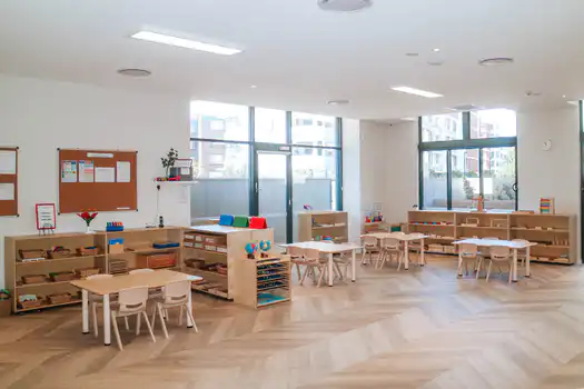 Toddler Montessori classroom at Lane Cove West Montessori Academy featuring natural timber furniture, child-sized tables, accessible learning materials, and bright open learning spaces.
