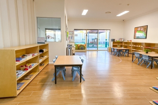 Montessori classroom at Auburn Montessori Academy with learning shelves and child-sized tables