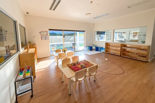 Montessori classroom at Auburn Montessori Academy with activity tables and learning shelves