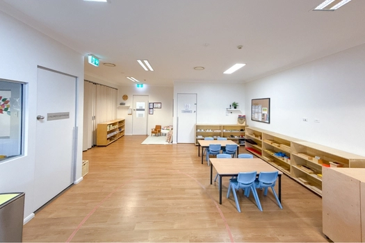 Montessori classroom at Auburn Montessori Academy with child-sized tables and open learning shelves
