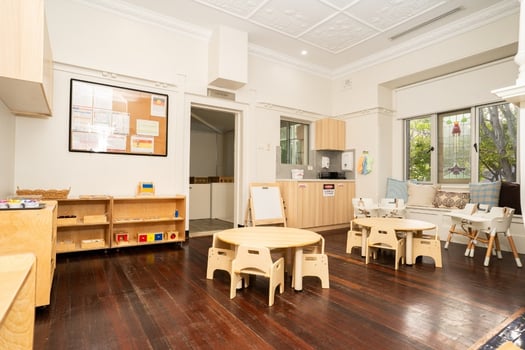 Montessori classroom with wooden furniture and learning materials at Balmain Road childcare centre