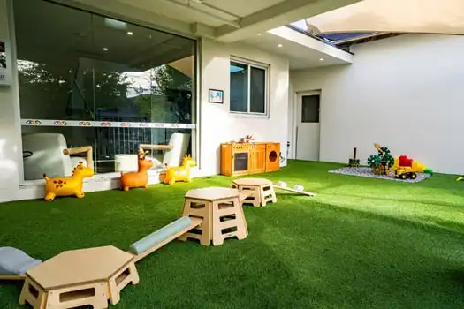 Montessori outdoor play area with balance equipment and toys at Balmain Road childcare centre