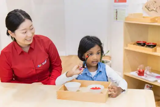 Child completing Montessori practical life activity at Chatswood childcare