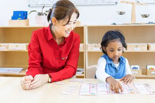 Educator supporting Montessori language activity at Chatswood childcare