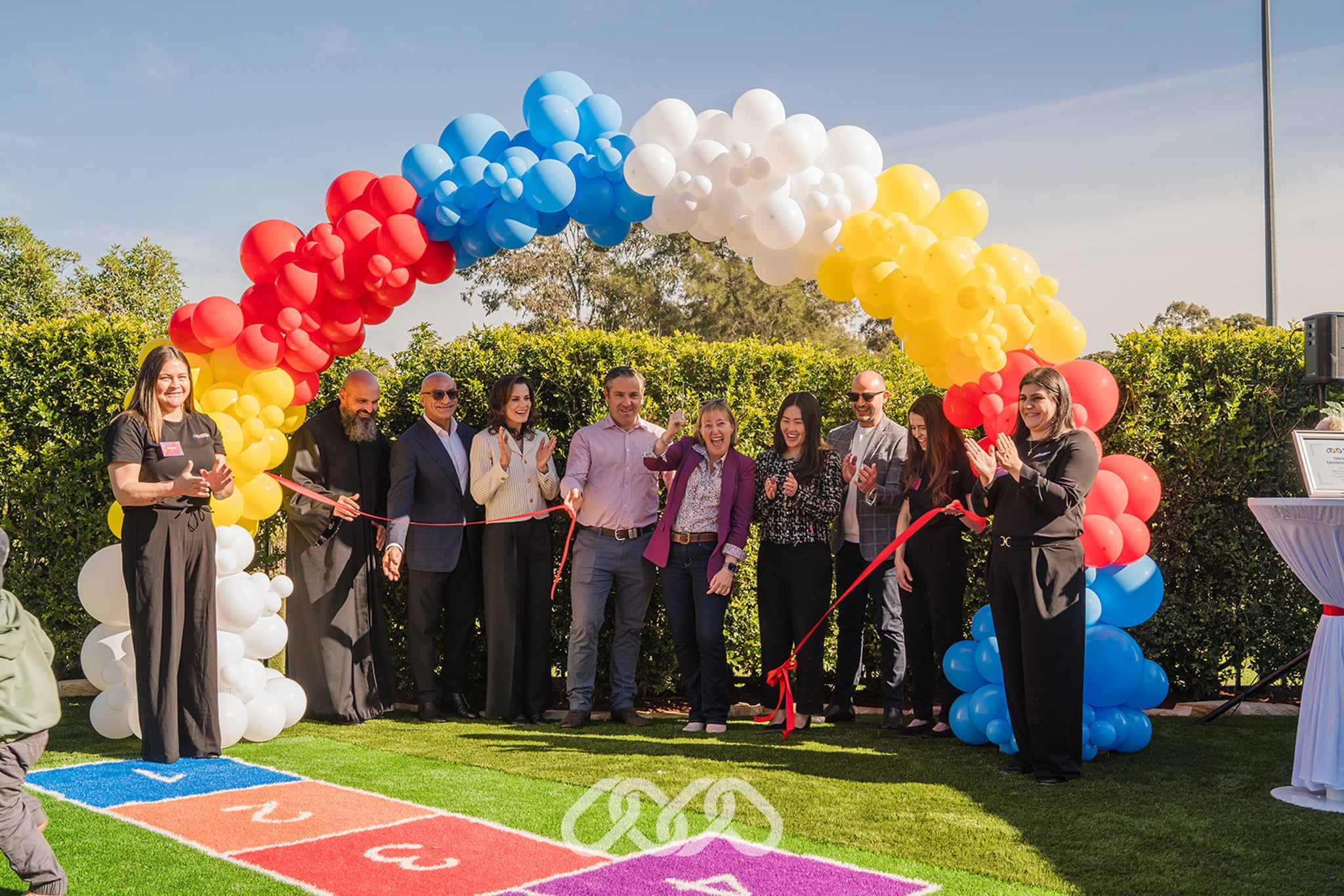 Official ribbon-cutting ceremony at Narellan Vale Montessori Academy, with Montessori Academy leadership and community leaders cutting the ribbon to mark the opening of the new Montessori childcare centre.
