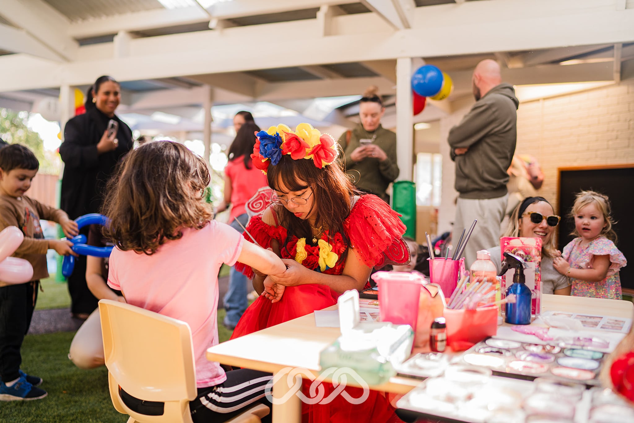 Children enjoy face painting activities during the Narellan Vale Montessori Academy Grand Opening celebration.