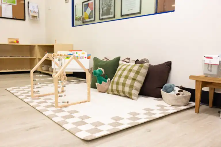 Montessori quiet play area at Mount Annan childcare with soft mat, cushions and wooden activity frame