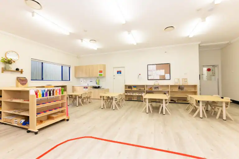 Montessori classroom at Mount Annan childcare centre with wooden tables, learning shelves and activity areas