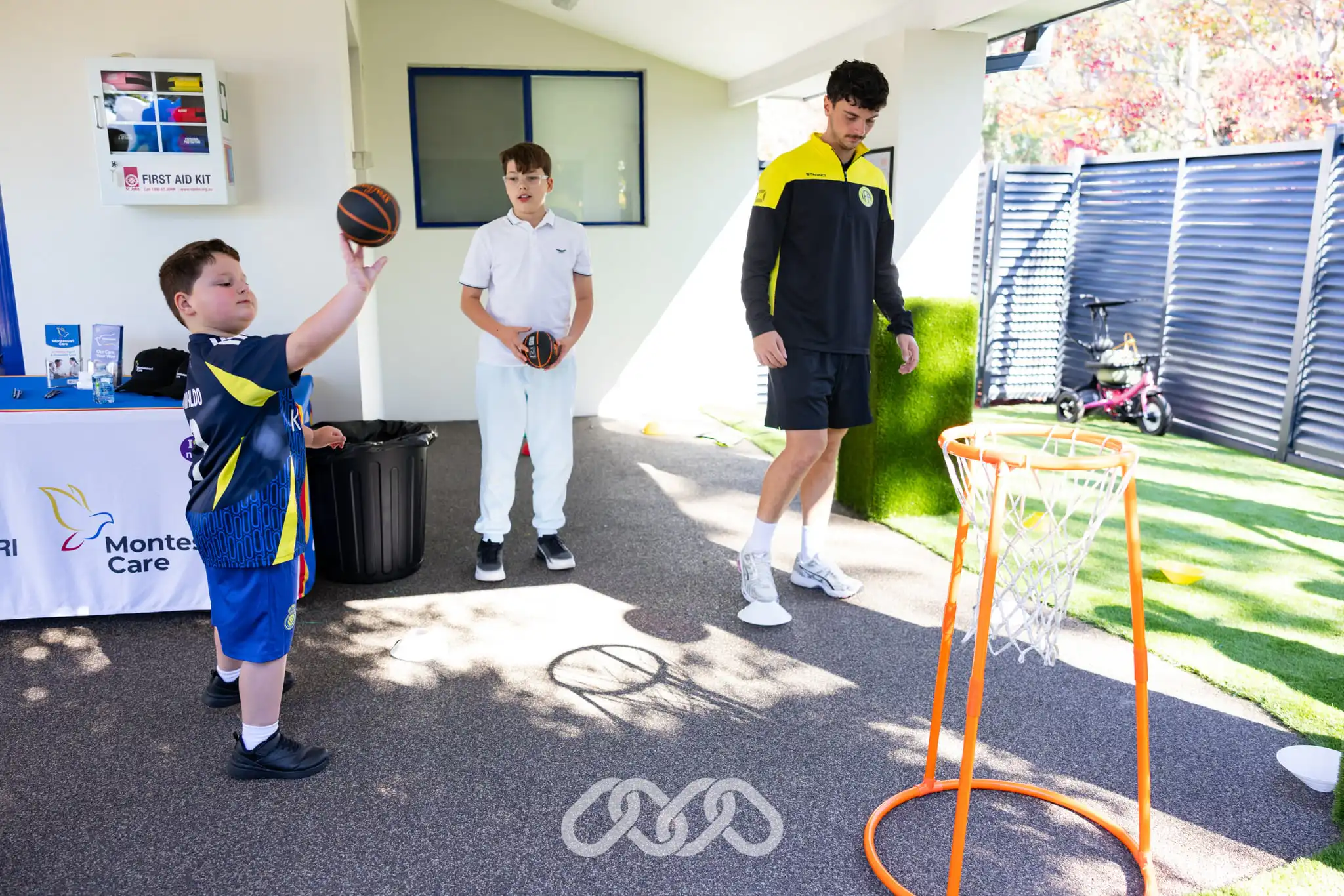Child participates in an IFA Sports basketball activity during the Mount Annan Montessori Academy Grand Opening.