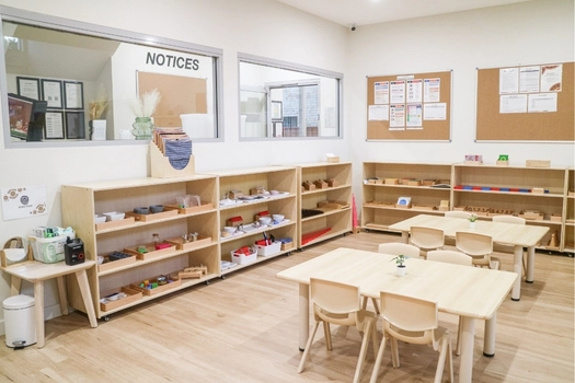 Montessori classroom at Revesby Montessori Academy with child-sized tables and prepared learning materials