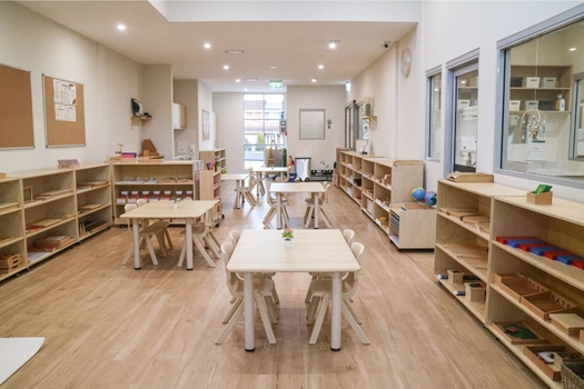 Montessori classroom at Revesby Montessori Academy with activity tables and learning shelves