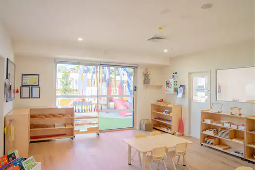 Toddler classroom at Winston Hills Montessori Academy with accessible Montessori learning materials and furniture.