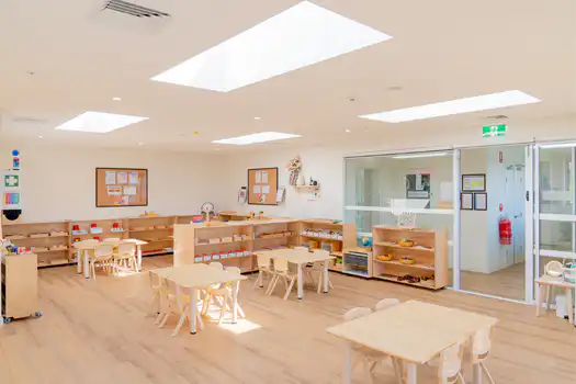 Preschool classroom at Winston Hills Montessori Academy featuring Montessori materials, natural light, and child-sized furniture.