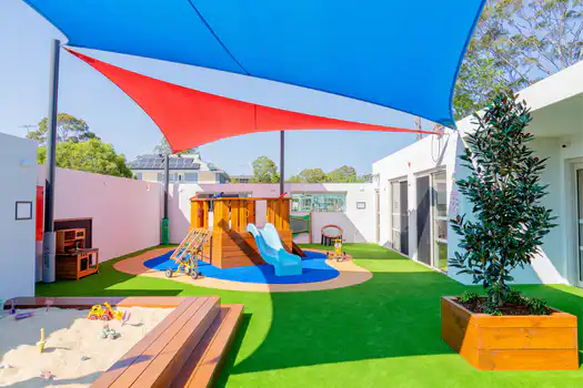 Outdoor play area at Winston Hills Montessori Academy with shaded spaces and engaging learning experiences.