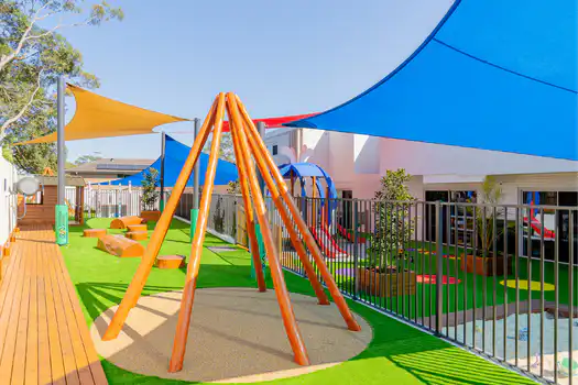 Winston Hills Montessori Academy outdoor playground featuring climbing equipment and open play spaces.