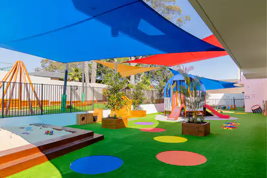 Shaded outdoor playground at Winston Hills Montessori Academy featuring engaging play and learning opportunities.