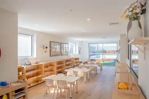 Montessori classroom interior at Winston Hills Montessori Academy featuring child-sized furniture and learning materials.